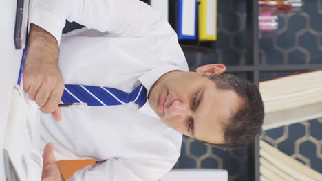 Vertical-video-of-Unhappy-and-bored-working-businessman.